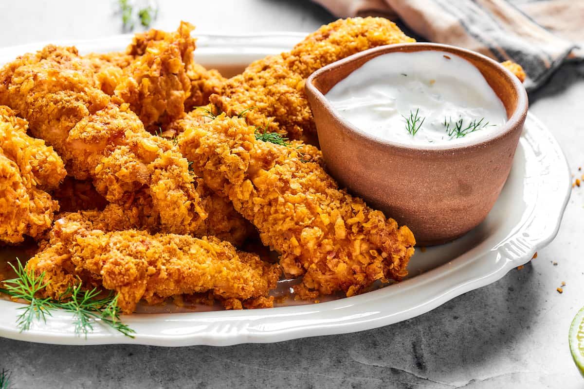 Air fryer chicken tempura on a platter with dipping sauce.