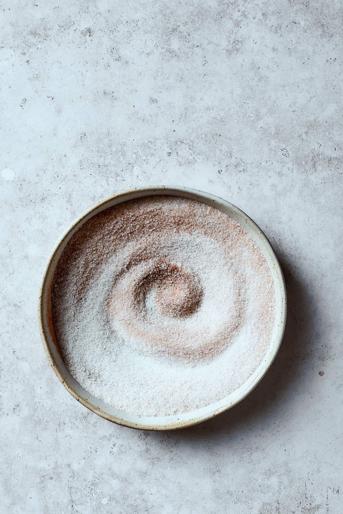 A bowl of cinnamon-sugar mixture.