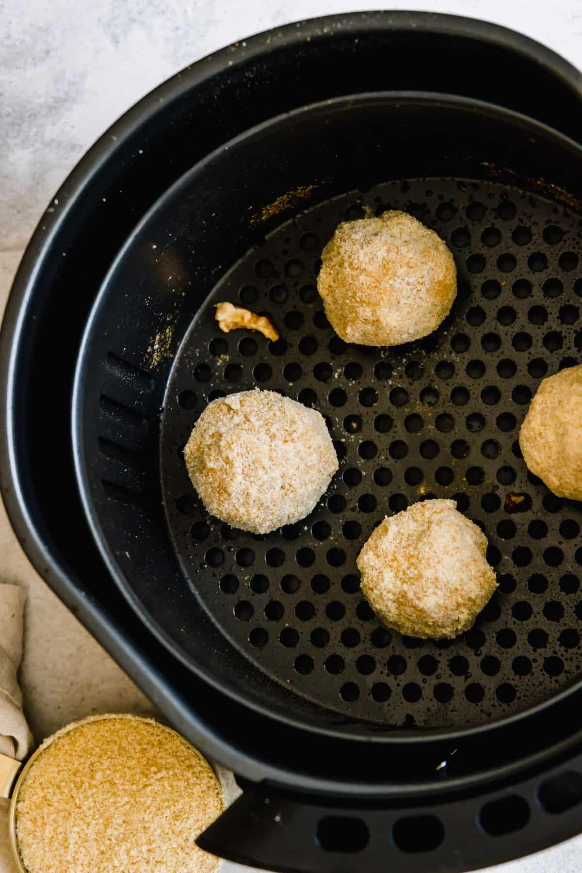 Four Jalapeno Popper Balls in an Air Fryer Basket