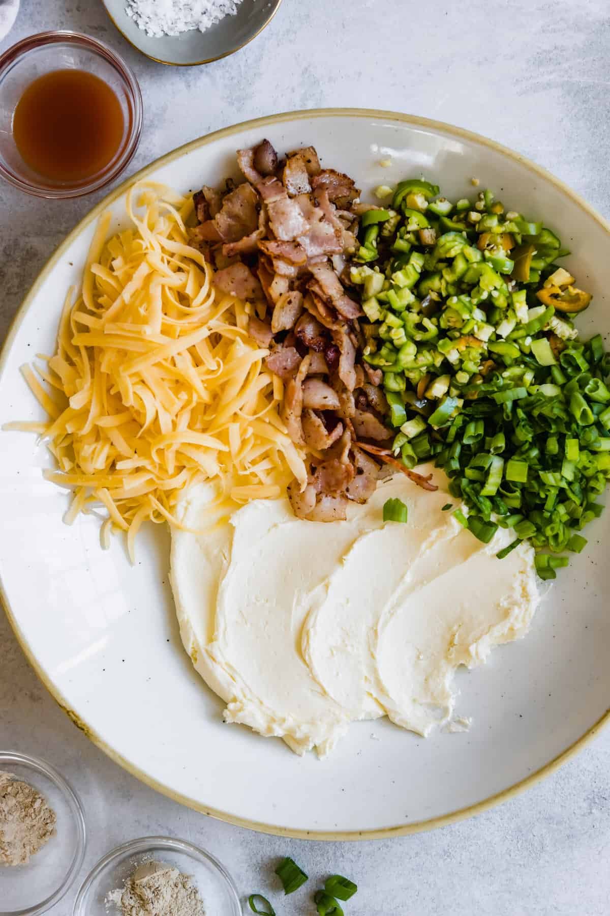 Sour Cream, Shredded Cheese, Bacon Bits and Scallions in a Bowl
