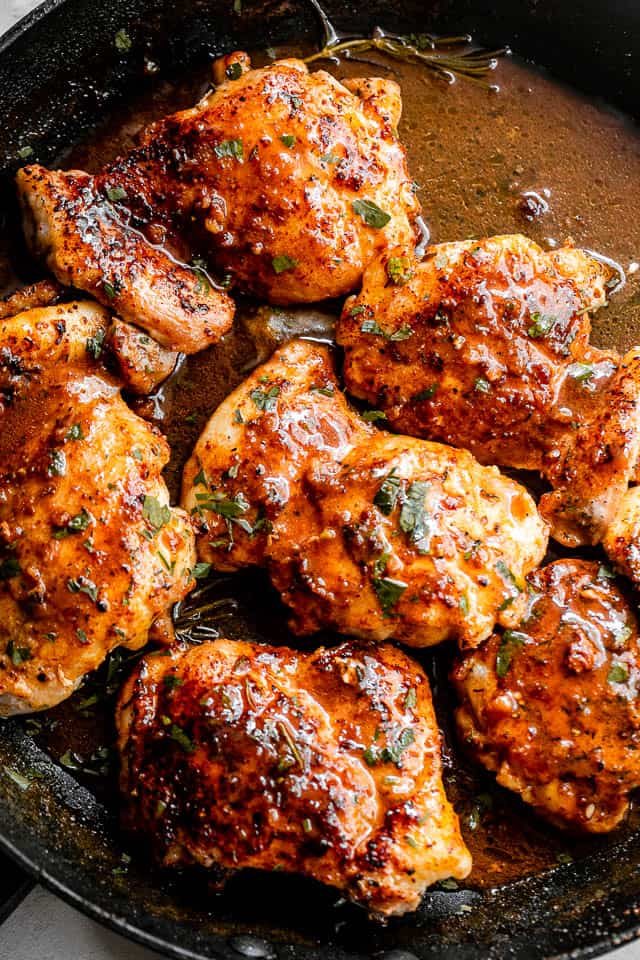 overhead shot of apple cider glazed chicken thighs inside a skillet