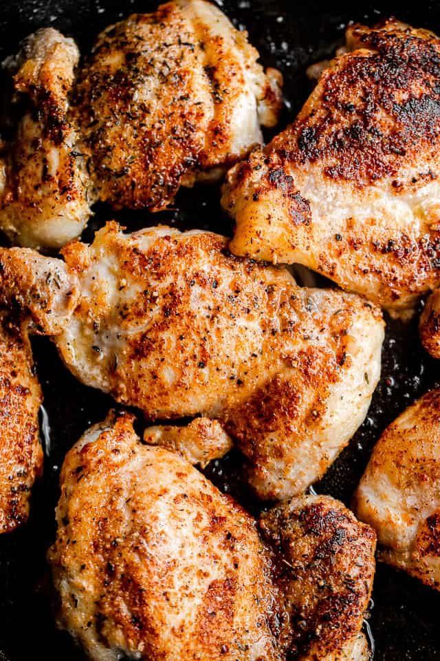 browning boneless chicken thighs in a skillet