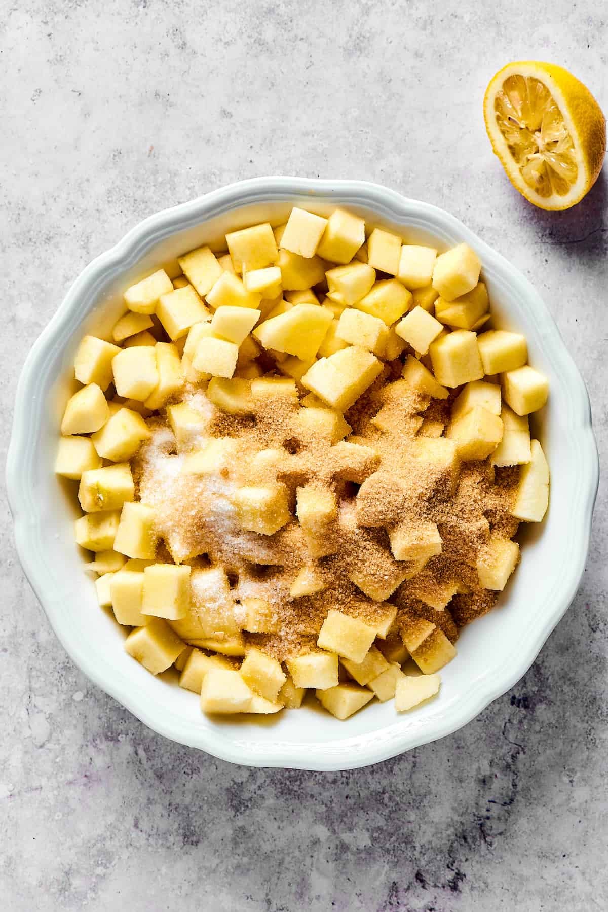 Apples drizzled with lemon and sprinkled with other ingredients.