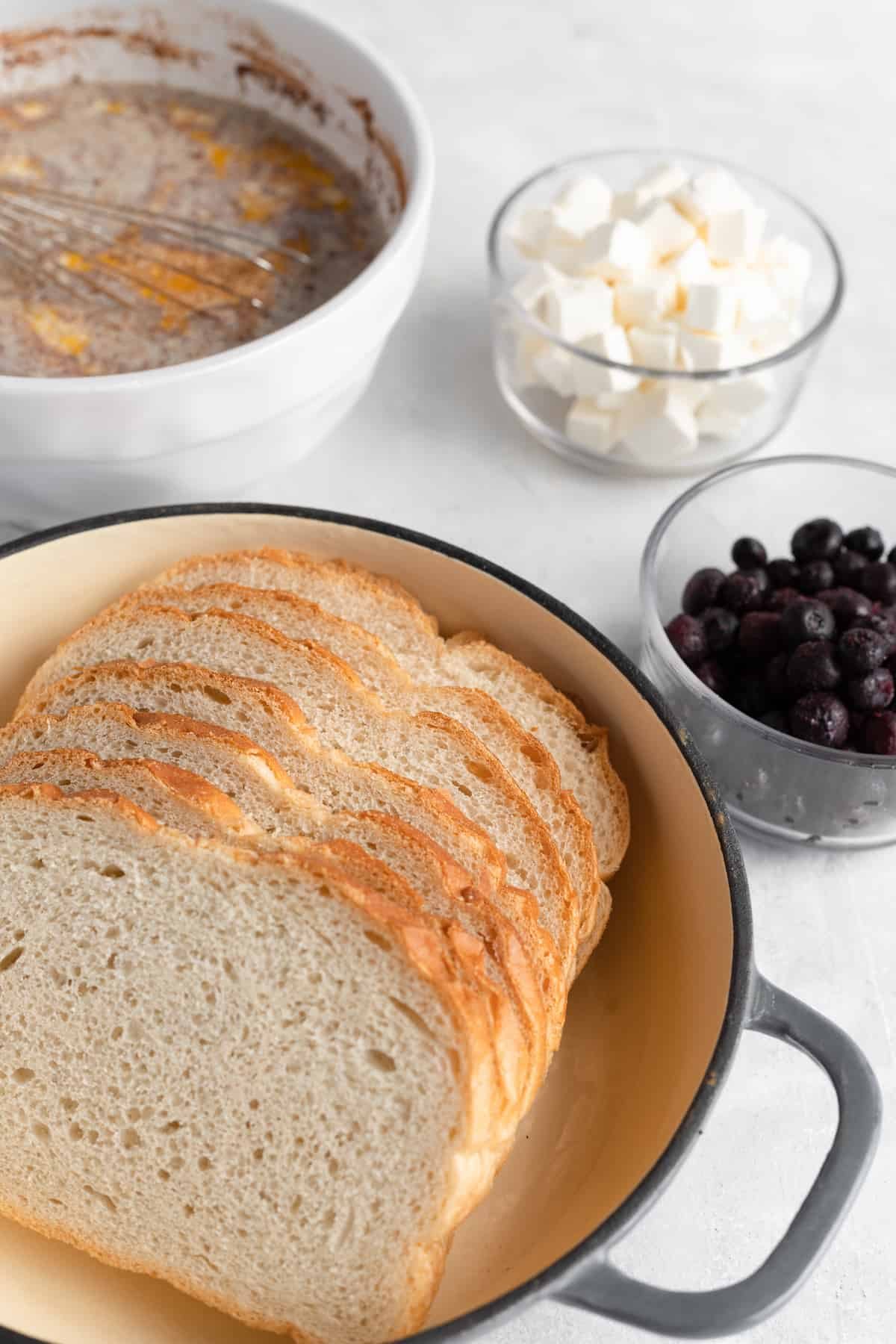 Sourdough Bread, Cream Cheese, Blueberries and the Rest of the Casserole Ingredients on a Countertop