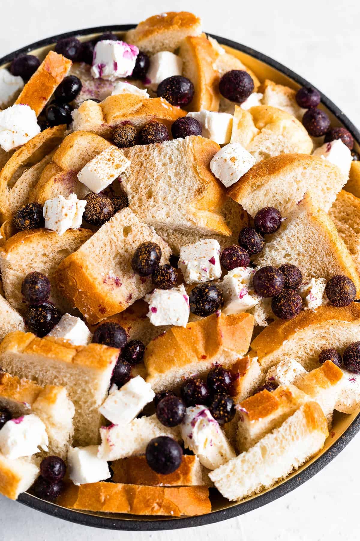 Cubed Sourdough Bread, Blueberries and Cream Cheese Cubes in a Black Bowl