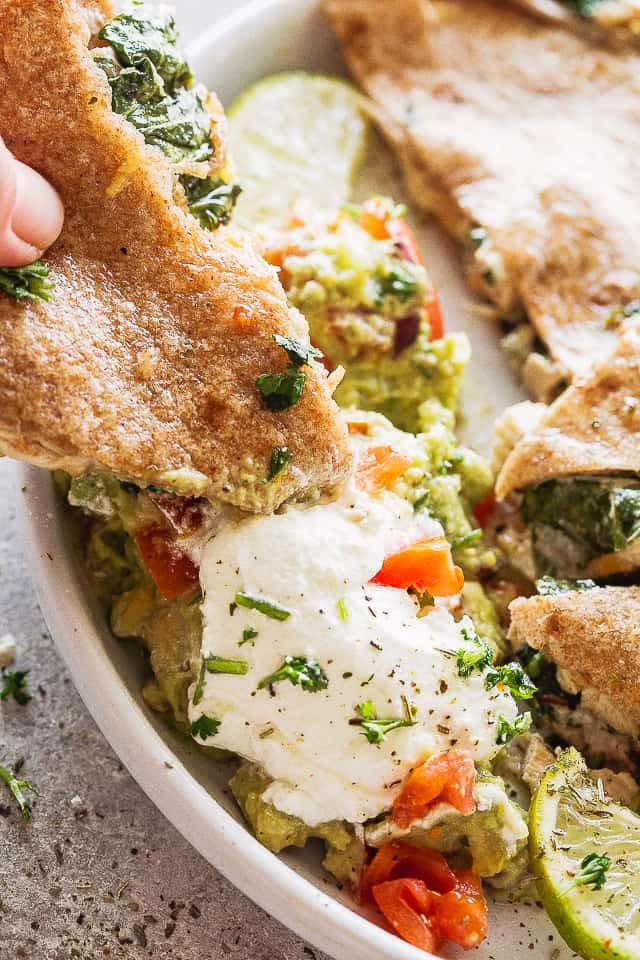 Dipping a baked quesadilla in sour cream and guac.