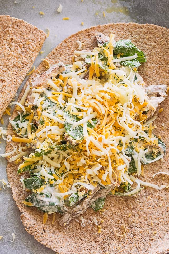 Adding the chicken and cheese mixture over a tortilla.