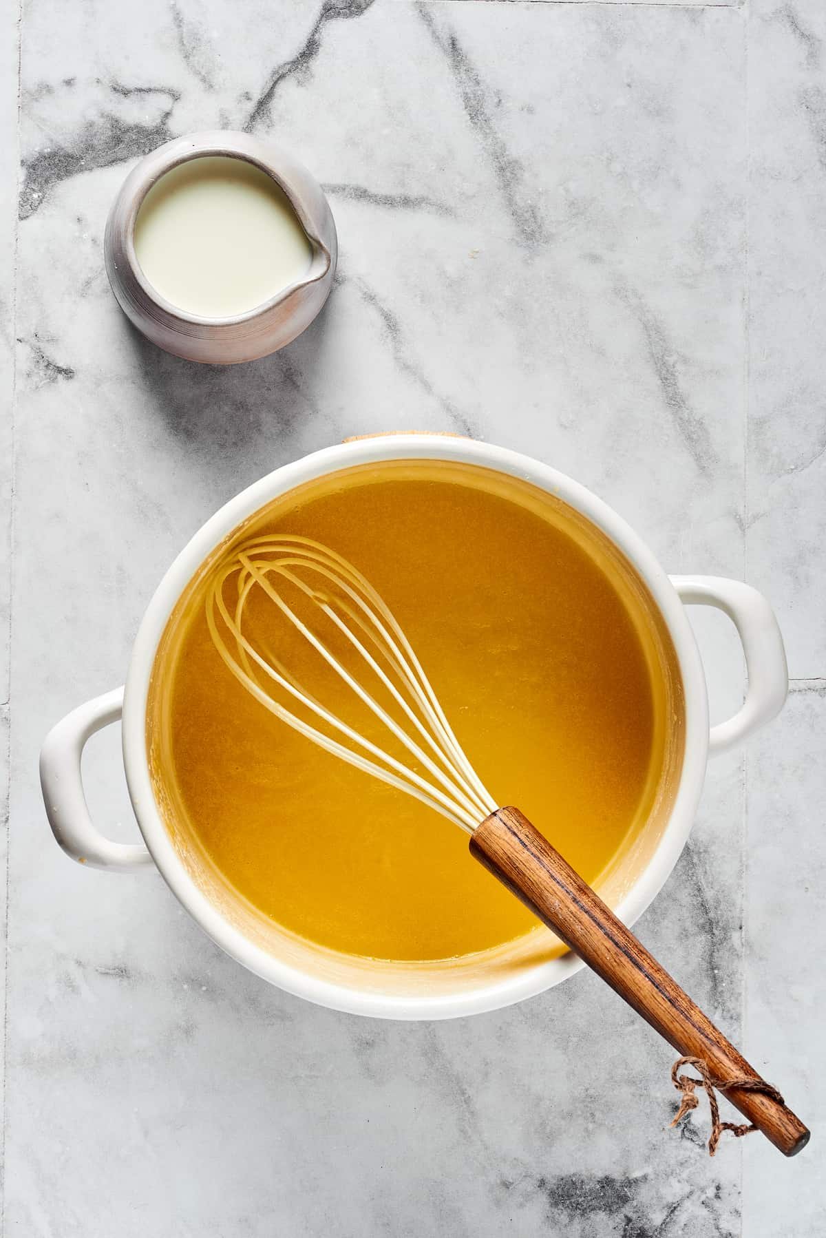 A blonde roux cooking in a pot.