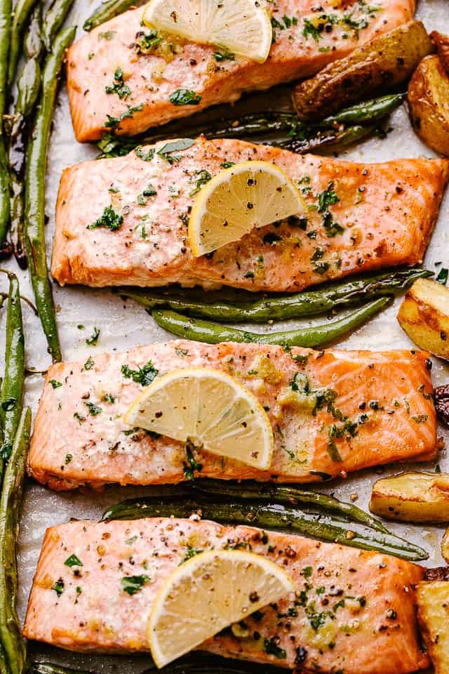 Oven-baked salmon topped with lemon slices.