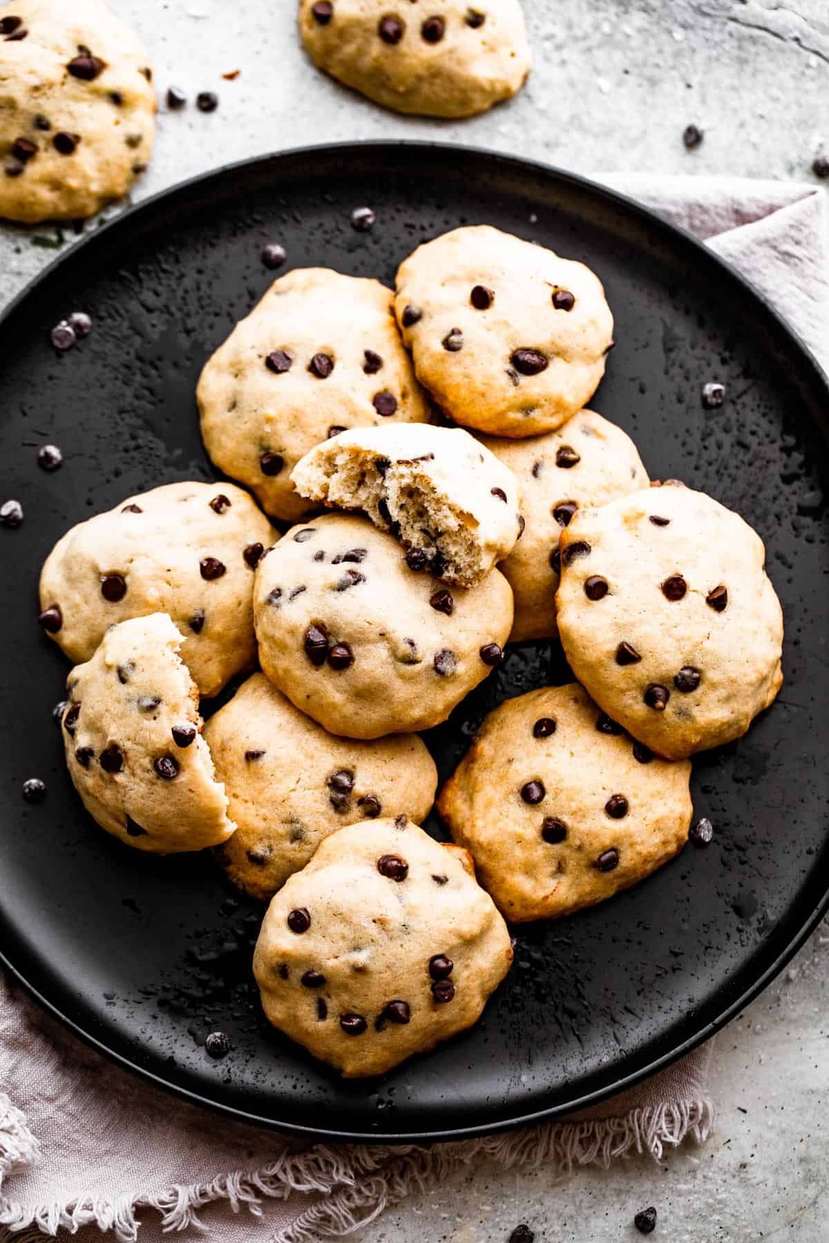 overhead shot of banana chocolate chips cookies served on a black plate.