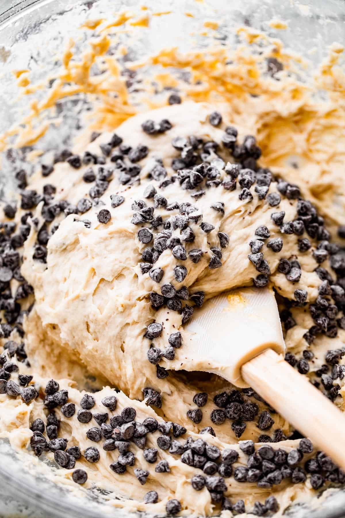 folding mini chocolate chips into a cookie batter.