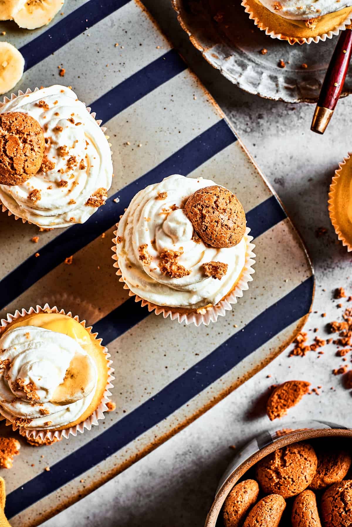 Overhead shot of frosted cupcakes on a decorative silver platter.
