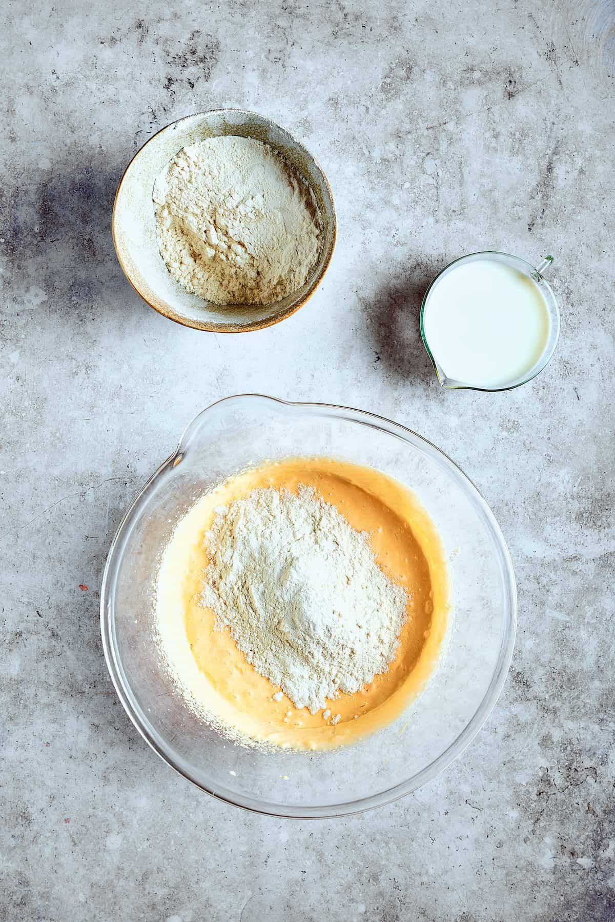 Adding dry ingredients to batter.