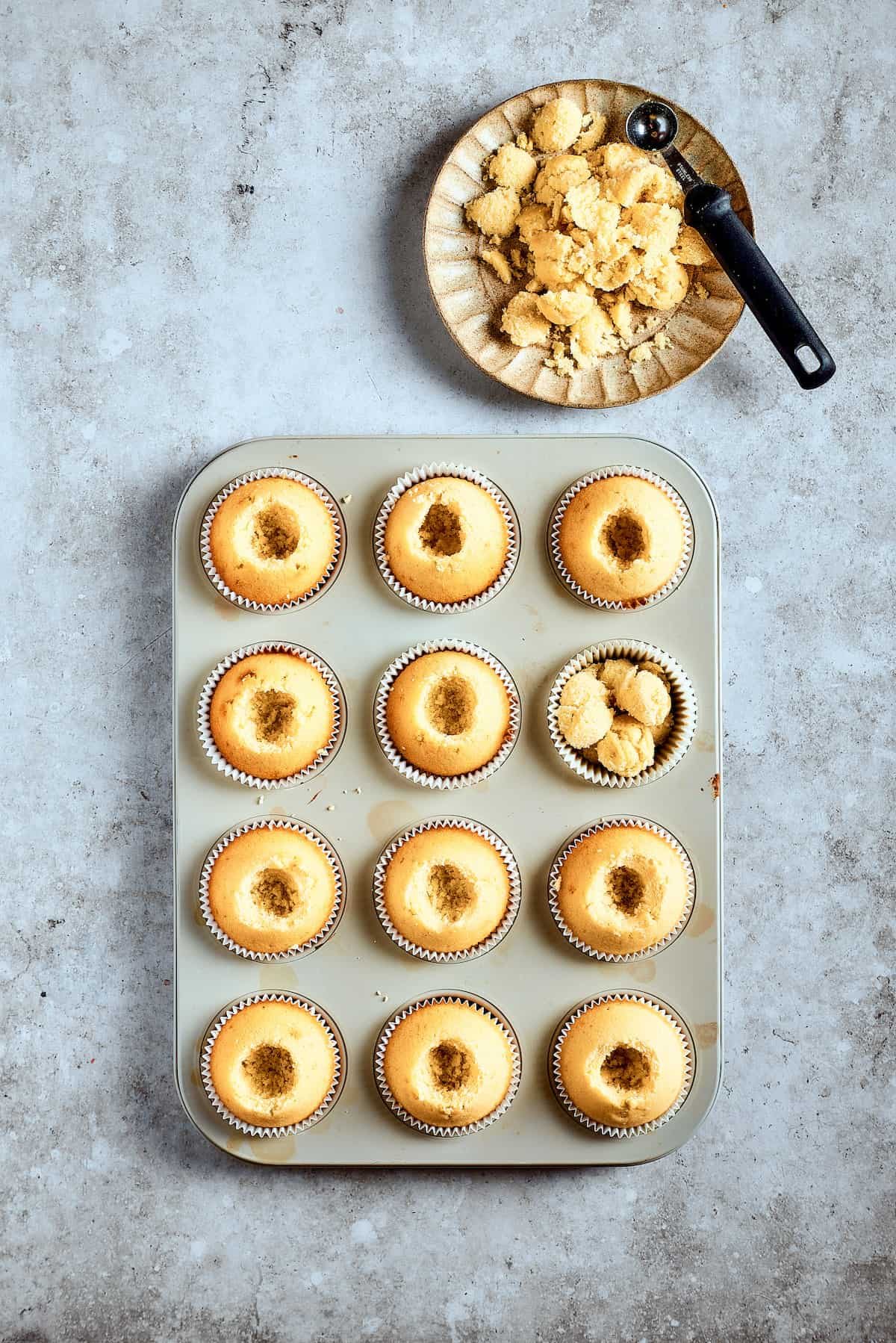Cupcakes in a cupcake pan, cores removed.