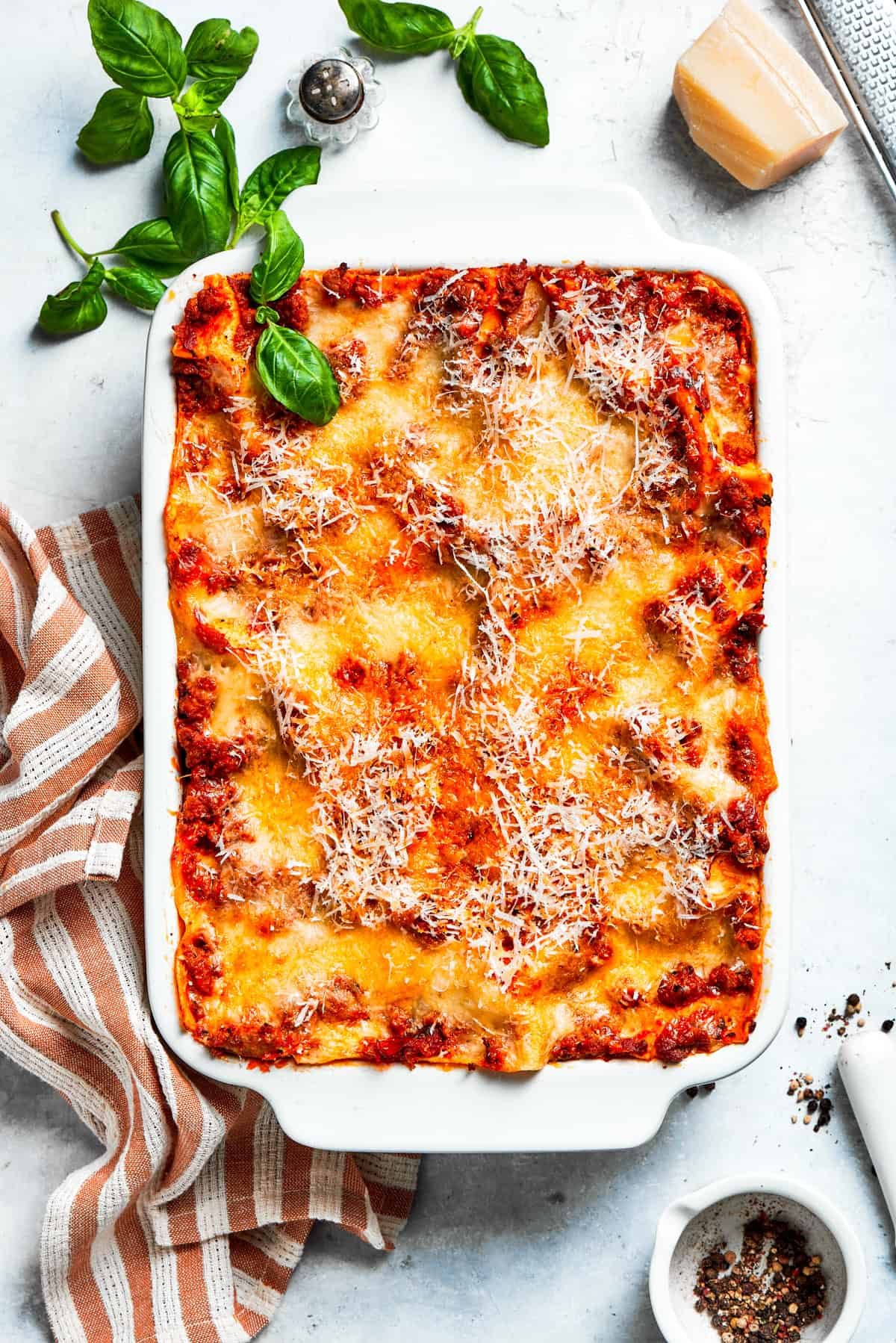 Overhead shot of lasagna in a white baking dish.