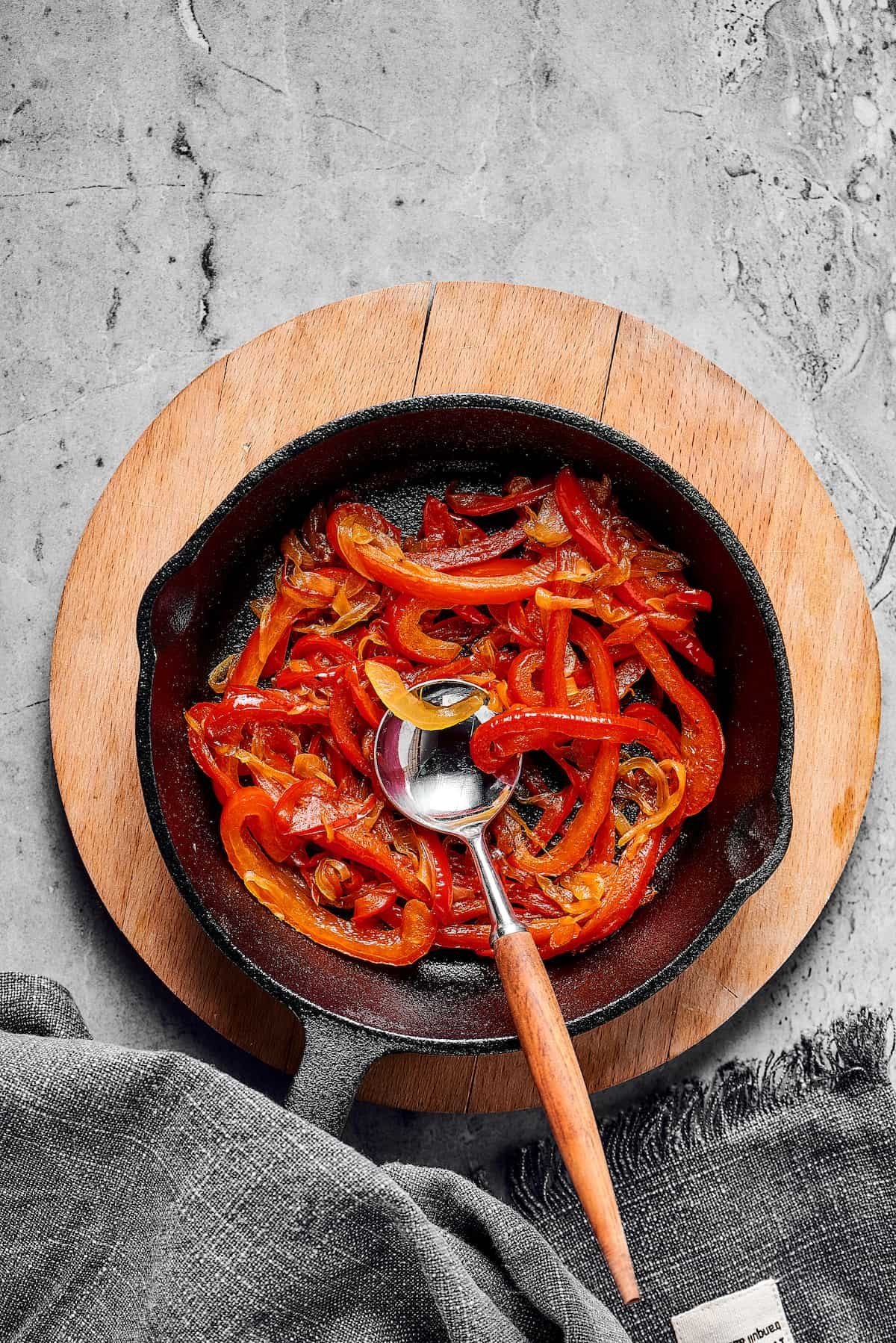 Cooked vegetables in a cast-iron skillet.