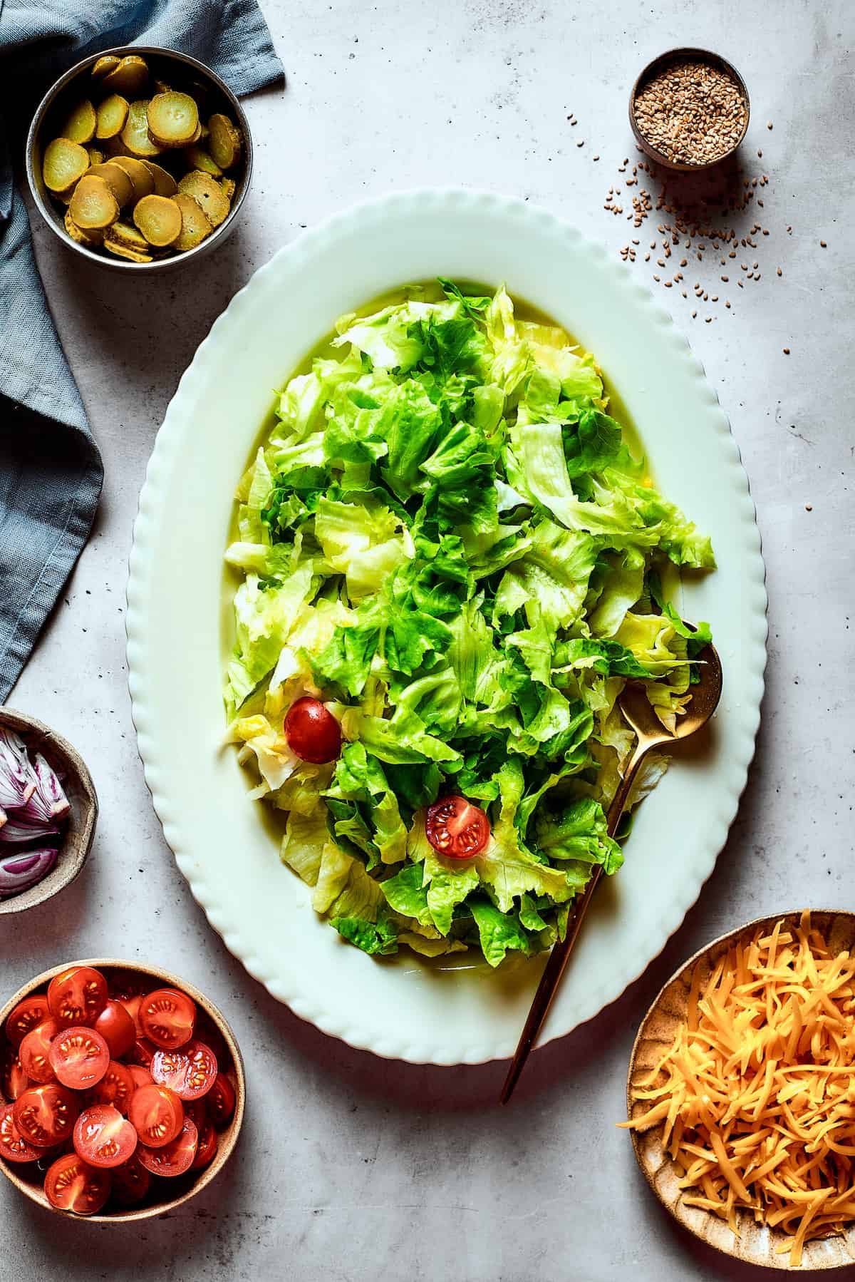 A leafy salad on an oval platter.