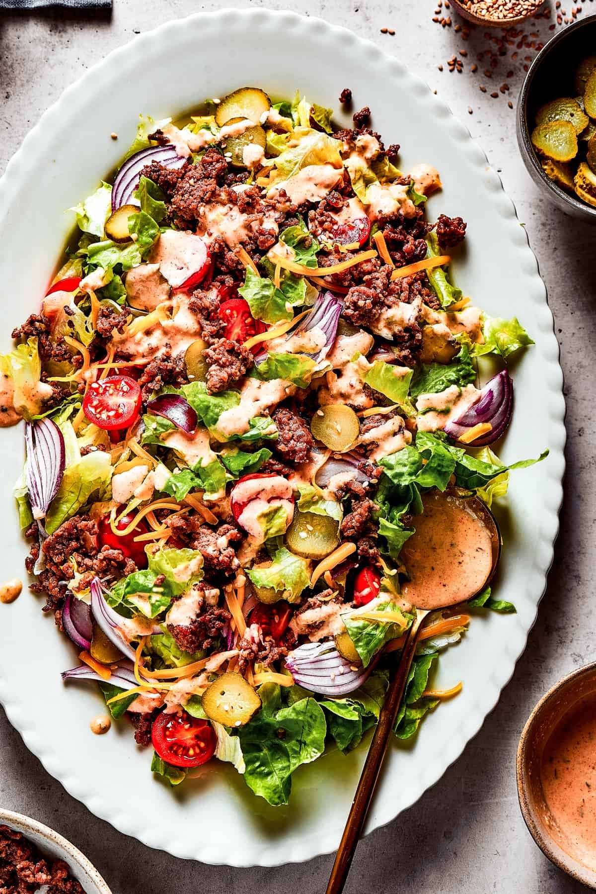 Overhead shot of a Big Mac salad on a white platter.