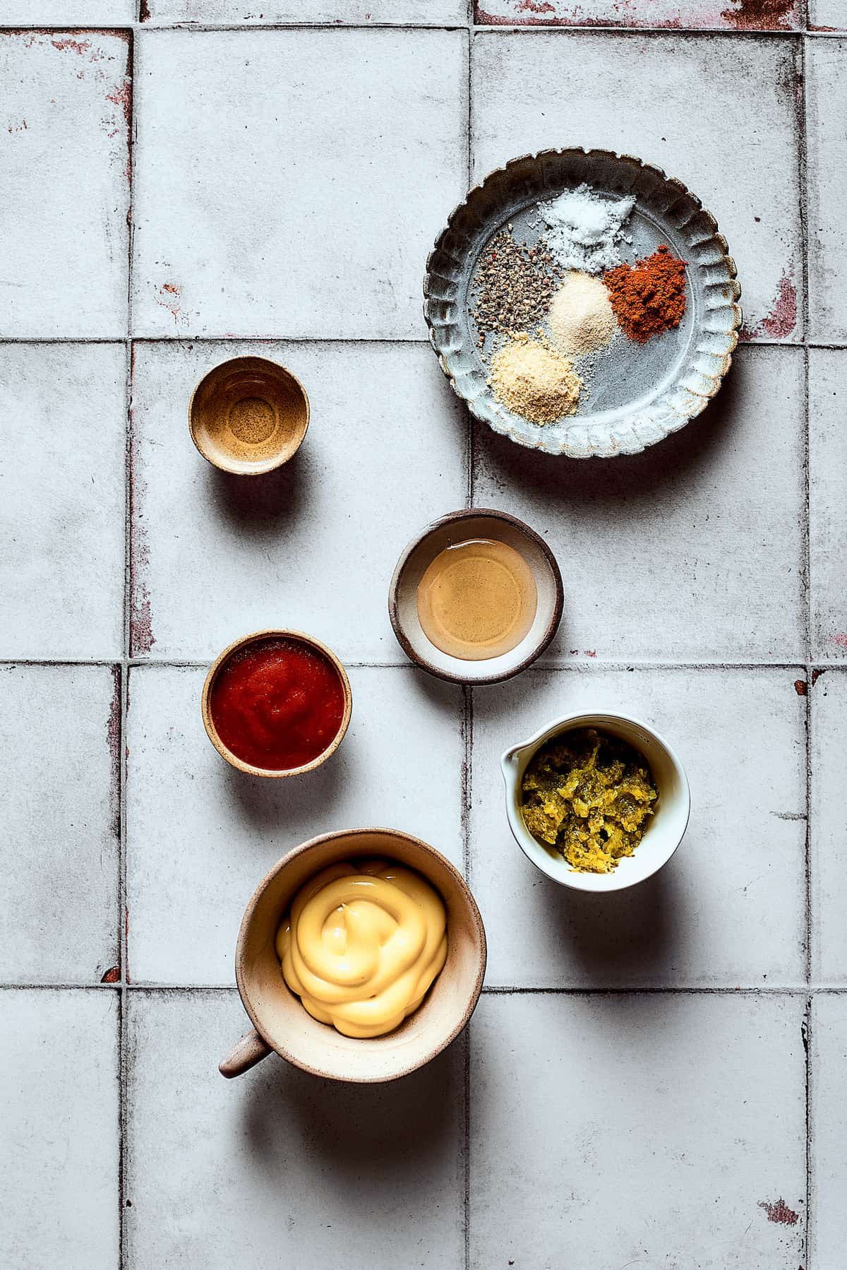 Dressing ingredients measured and arranged on a work surface.