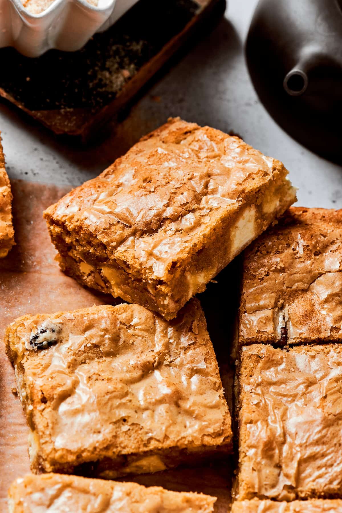 A side view of a blonde brownie on top of more brownies.