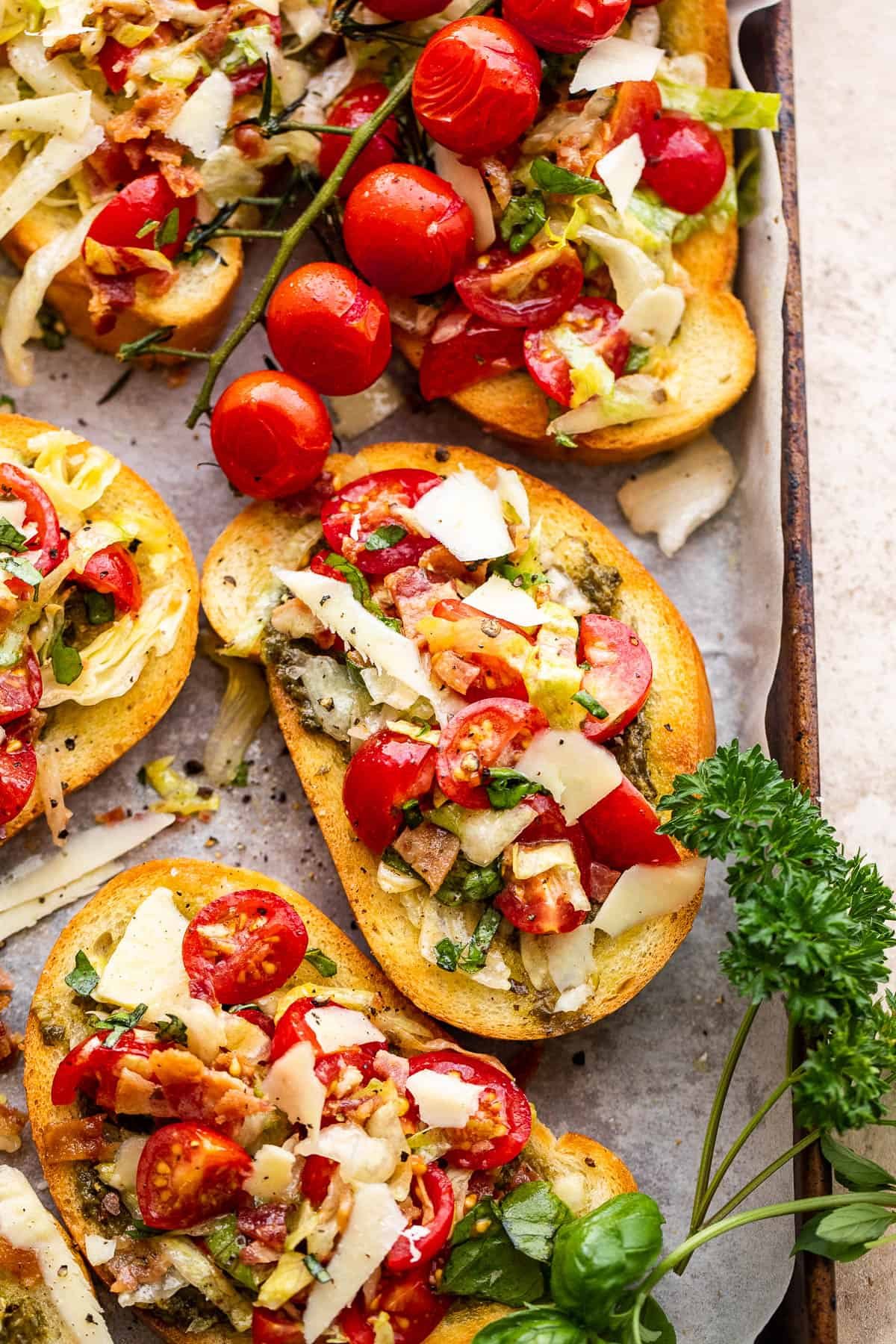 toasted bread slices topped with tomatoes, bacon, and lettuce
