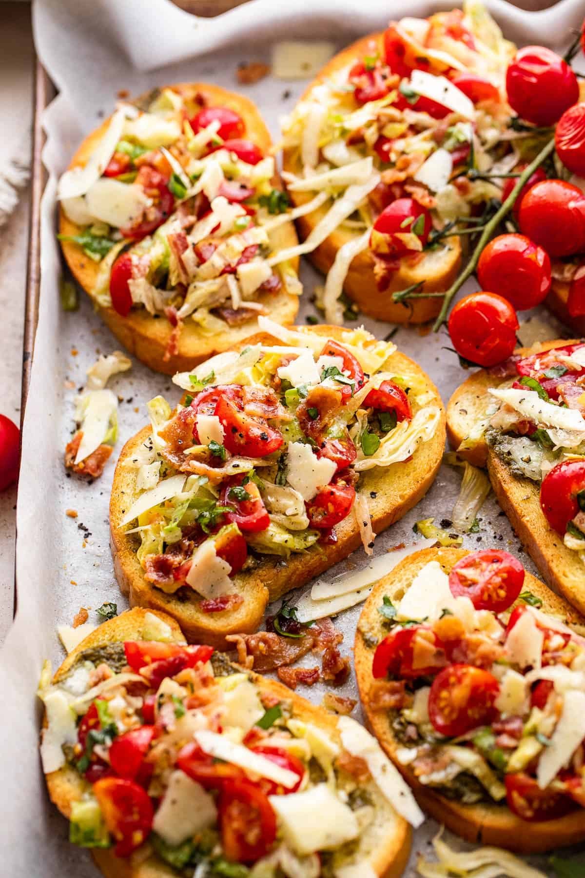 bacon, lettuce, and tomato topped toasted bread slices served on a tray