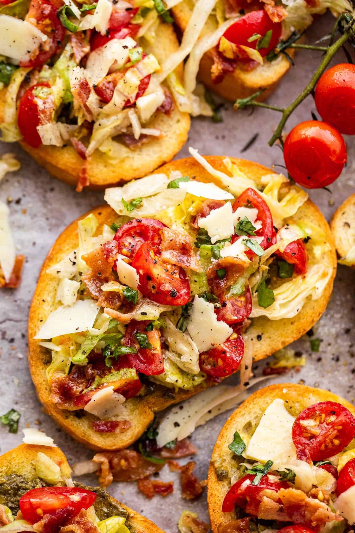 toasted bread topped with bacon, lettuce, and tomato salad