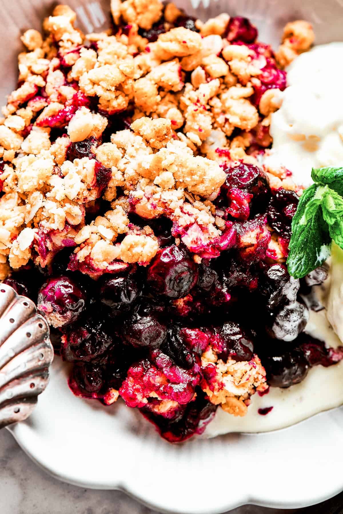 Close-up shot of baked blueberries under a crisp topping.