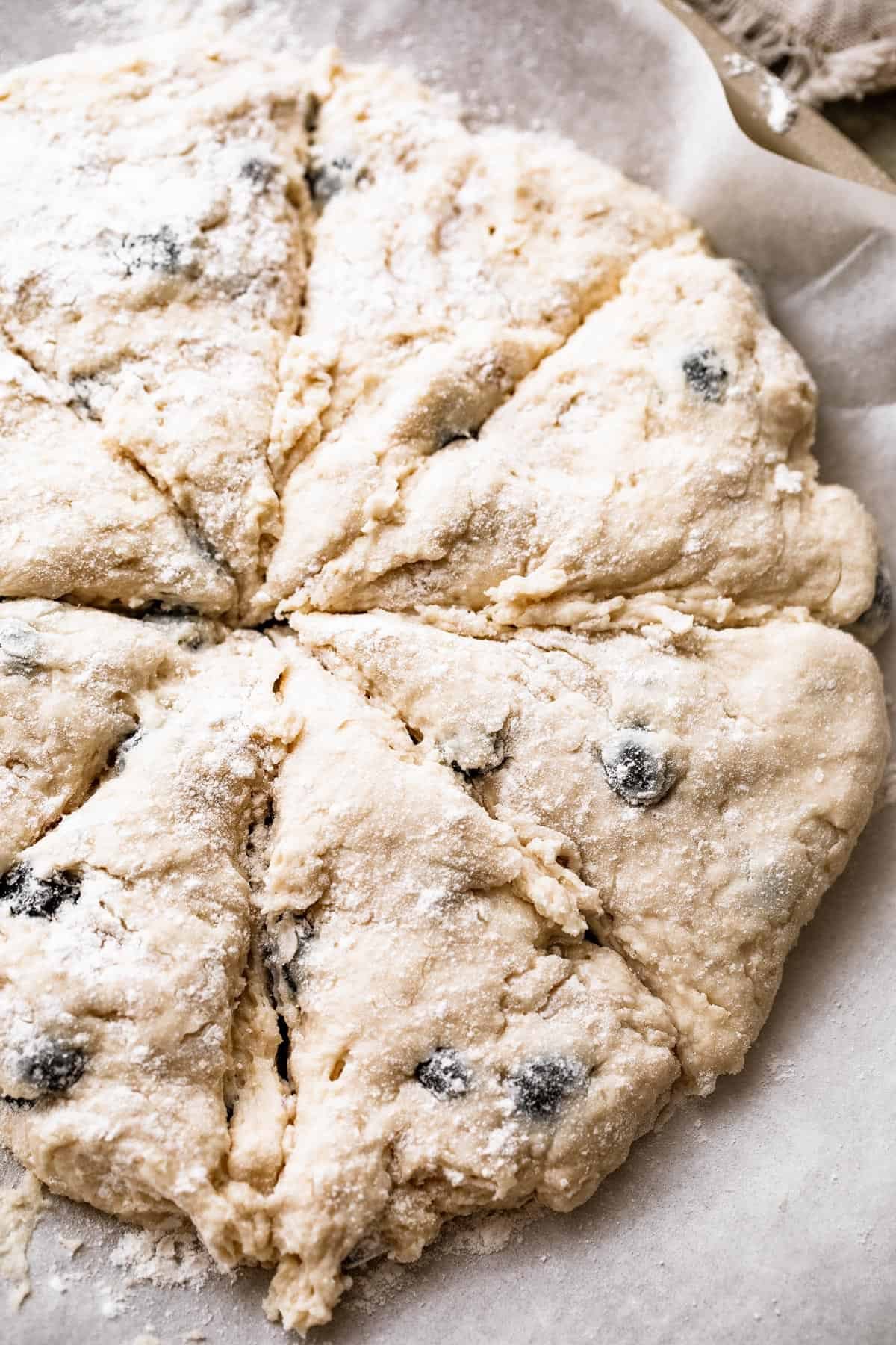 a round loaf of dough cut into eight slices