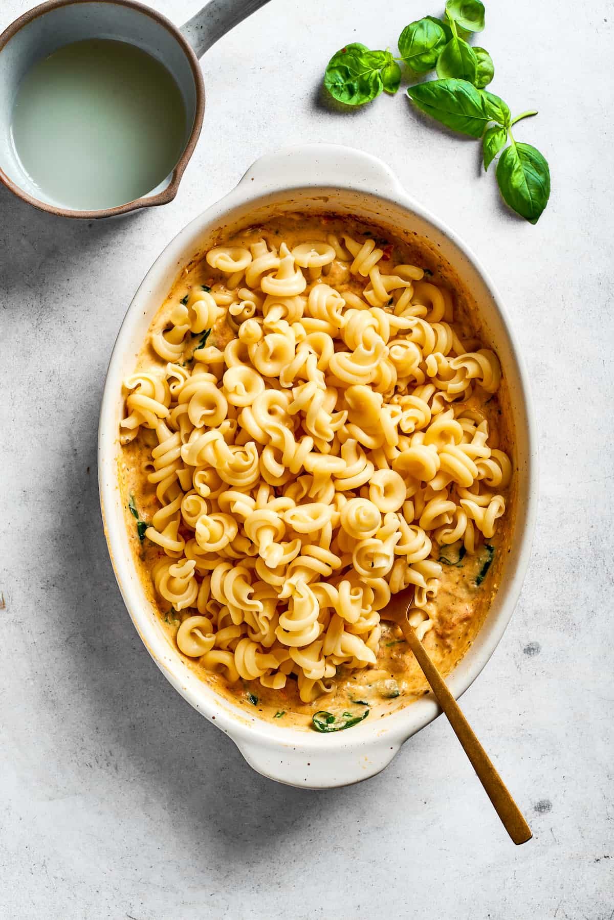 Pasta is stirred into the casserole.