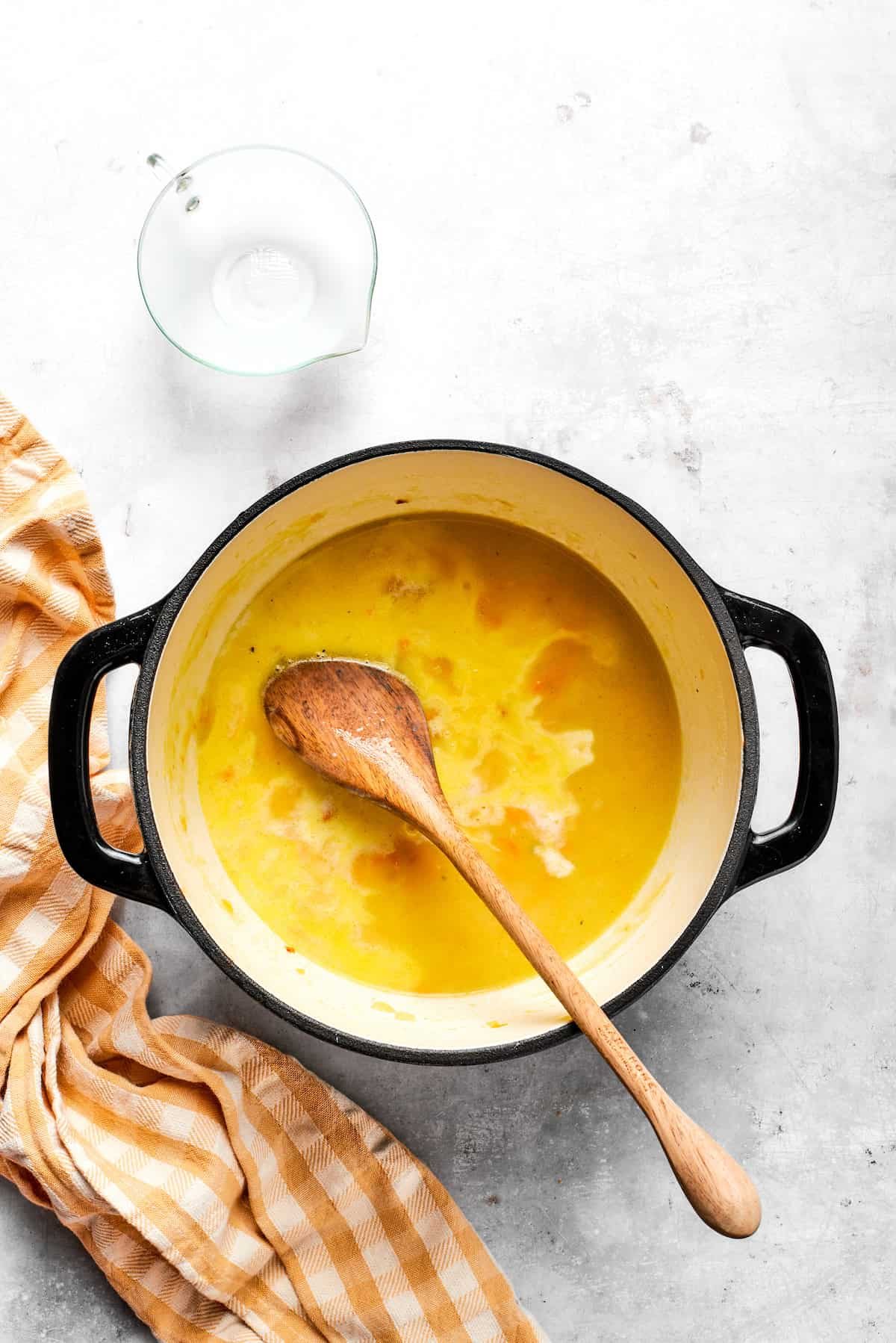 Adding milk to the pot.