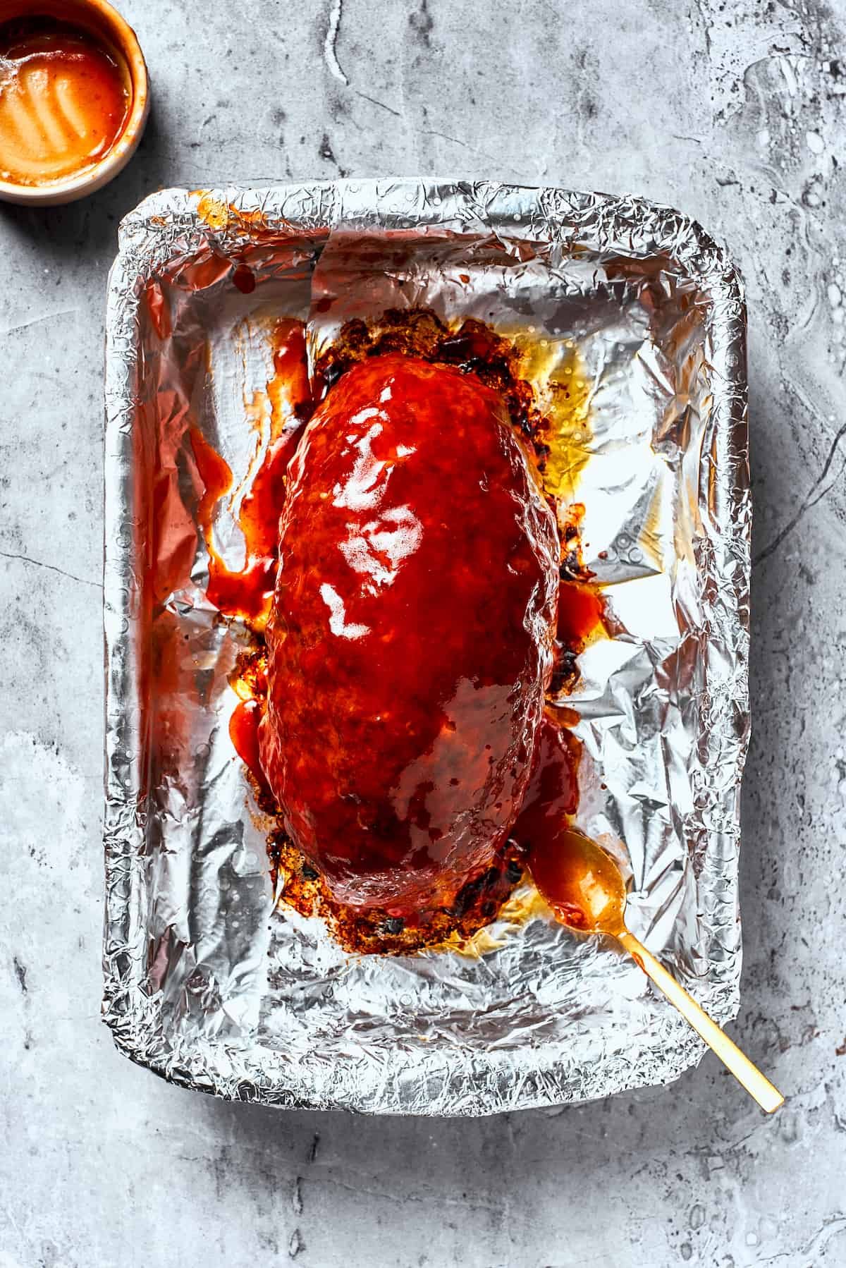 A meatloaf is topped with brown sugar glaze.