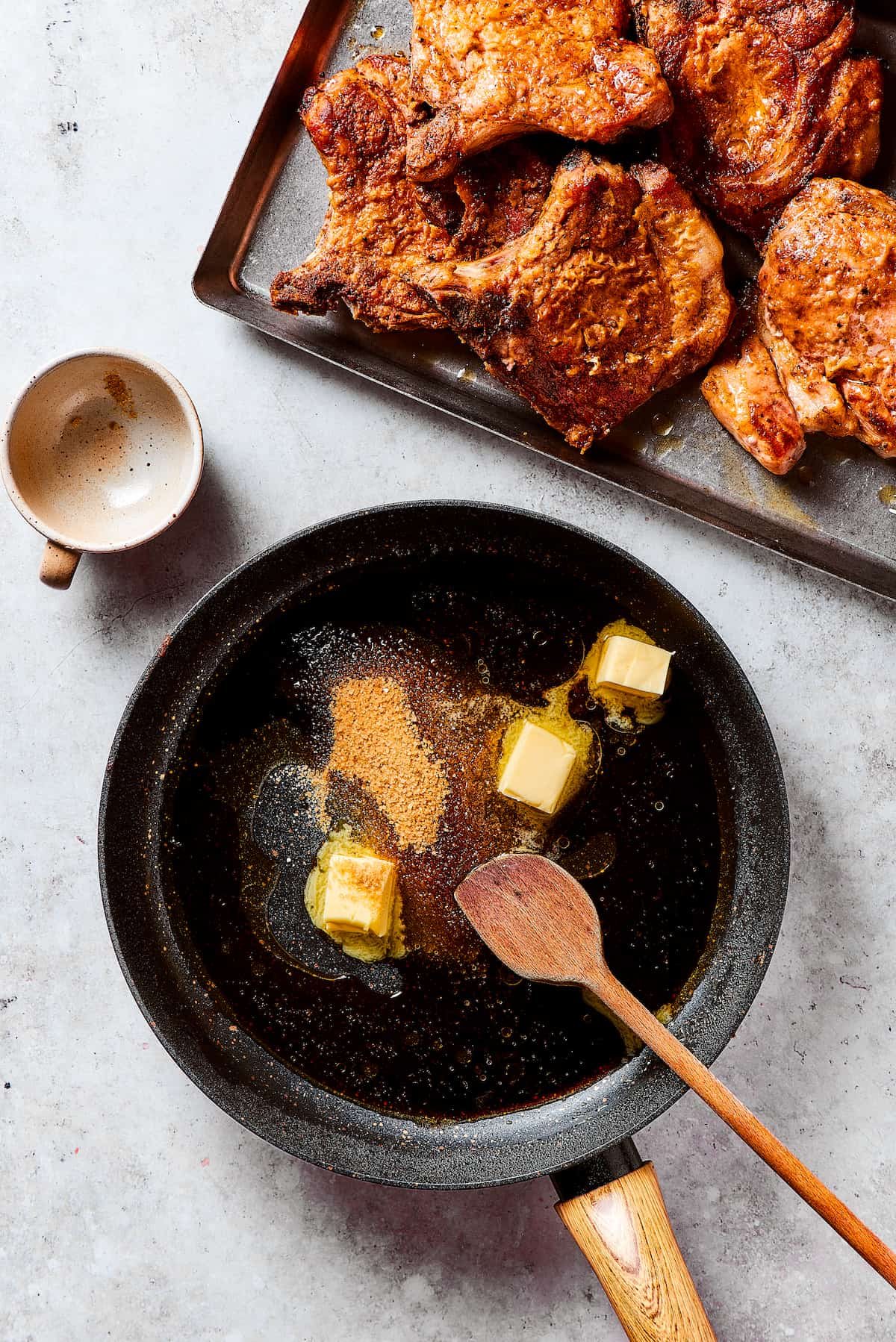 Making pan sauce with butter and brown sugar in a skillet.