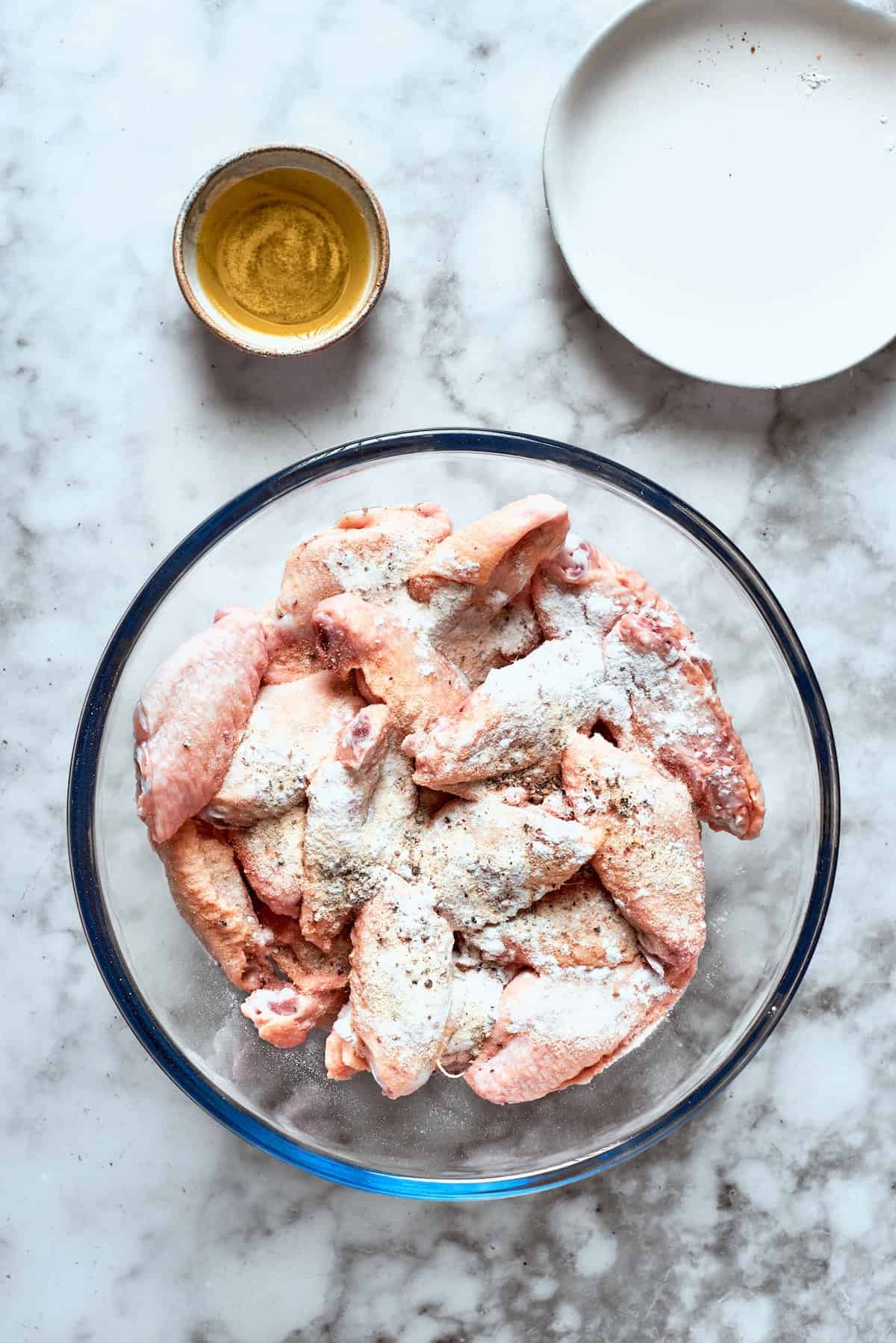 The chicken is mixed with flour.