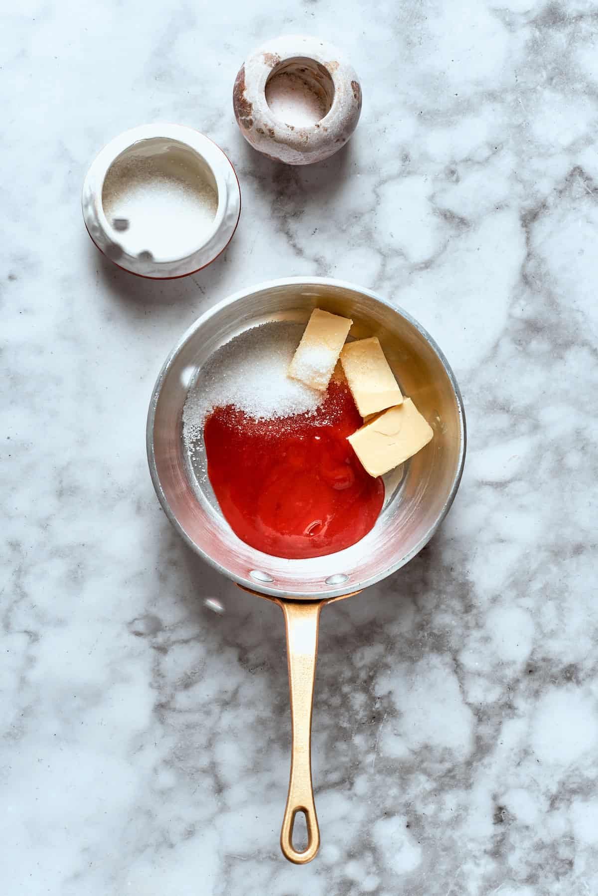 The sauce ingredients are added to a pot.