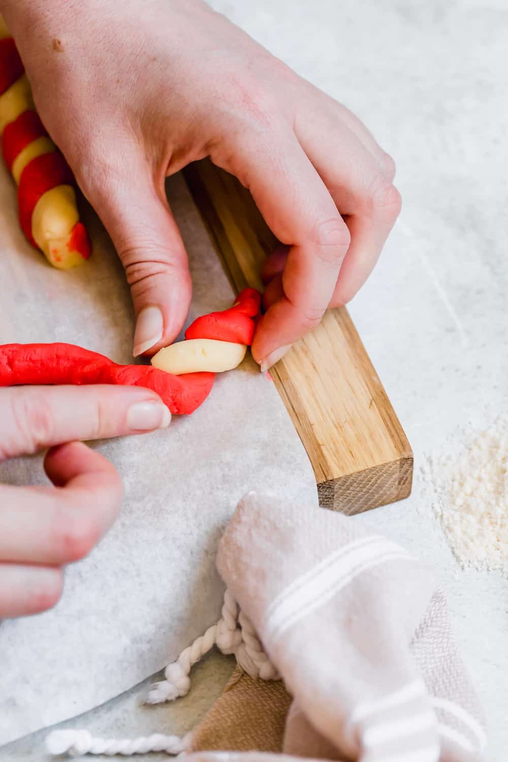 Red and White Cookie Dough Being Twisted Together