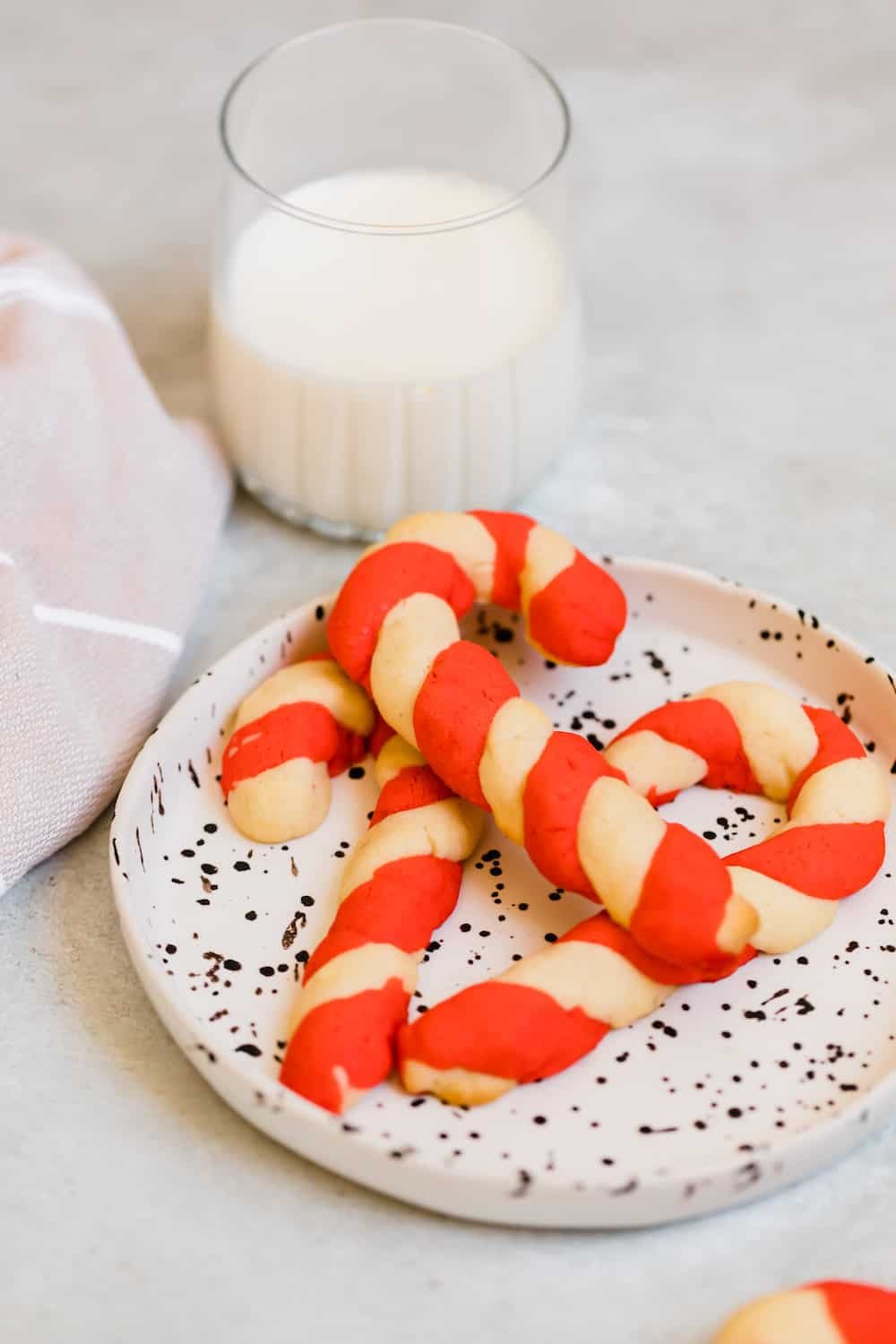 A Pile of Candy Cane Cookies on a Black and White Plate