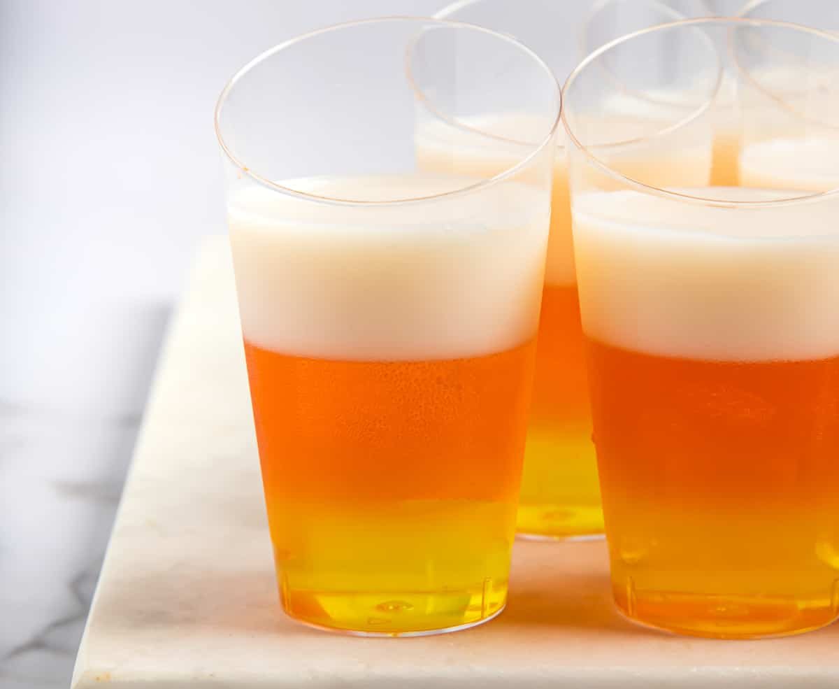 Jello shots with yellow, orange, and white layers.