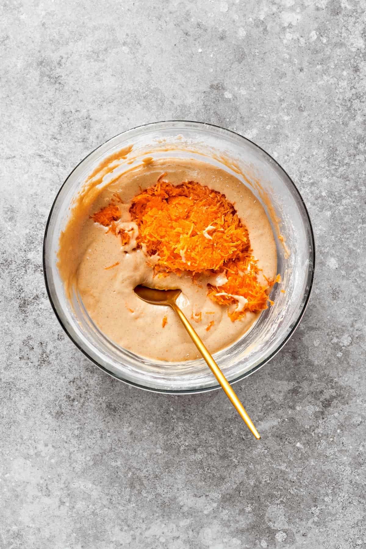 Carrots are added to carrot cake batter.