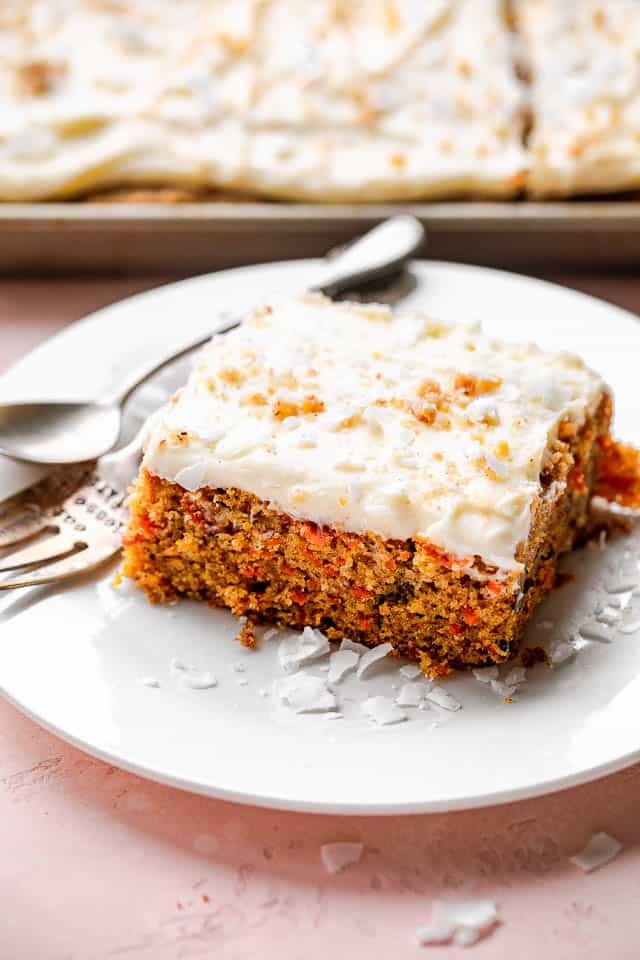 A slice of carrot cake on a white plate.