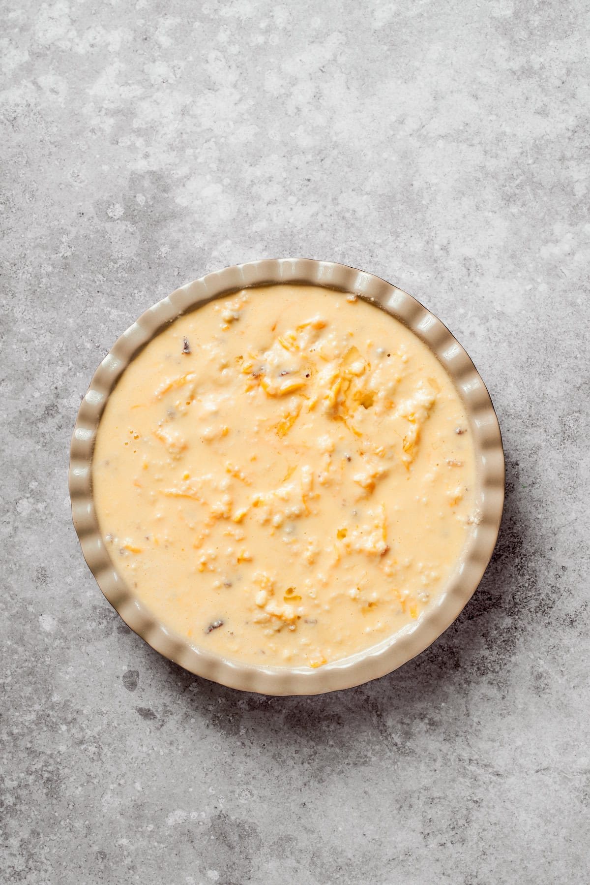 Biscuit dough added to a pan of cheeseburger pie.