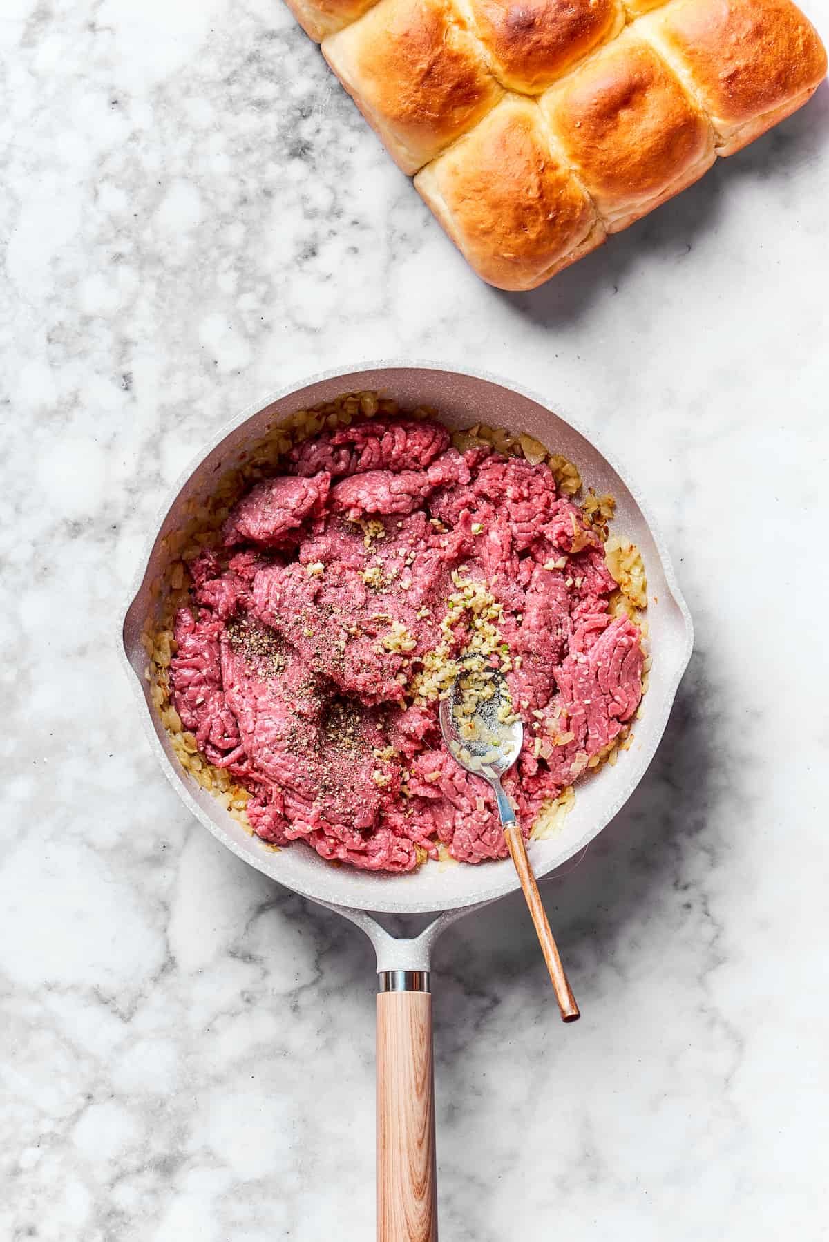 Meat is added to the skillet.
