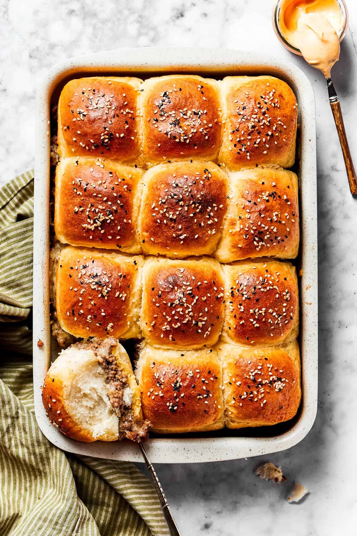 Cheeseburger sliders in a baking dish.