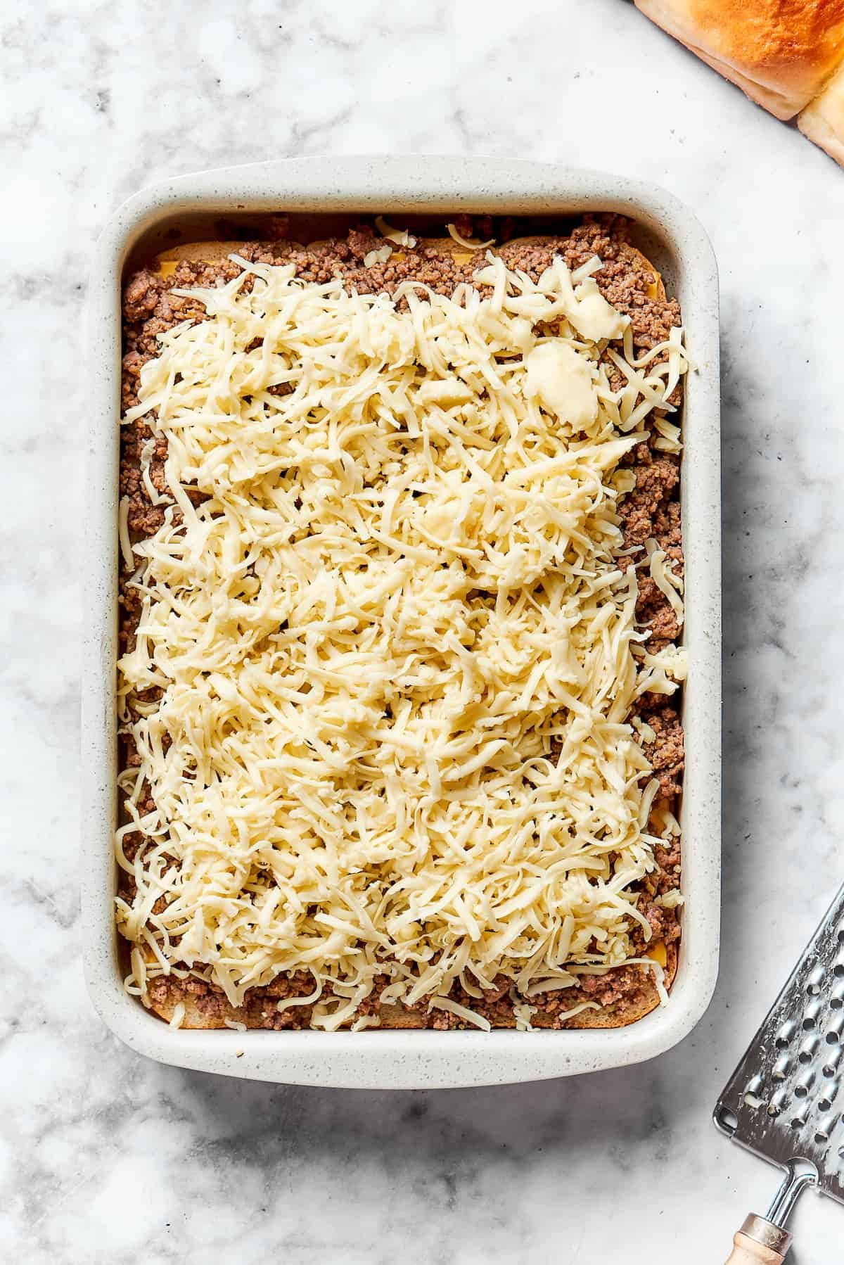 Shredded cheese tops the meat.