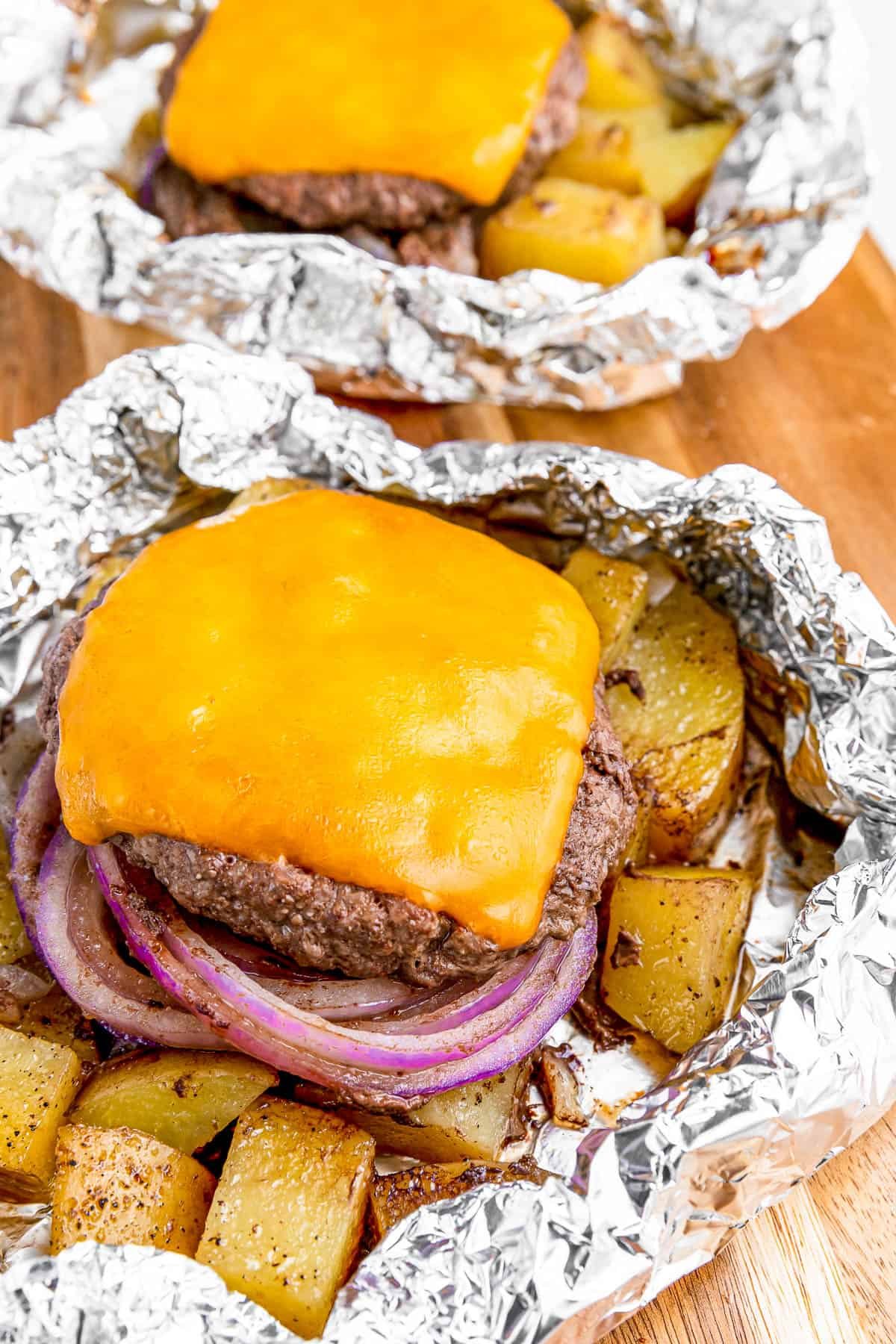 Cheeseburger in foil with melted cheese