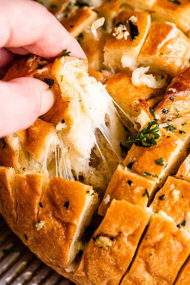 pulling apart garlic bread