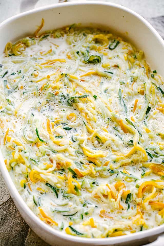 overhead shot of prepped casserole with spiralized zucchini and squash