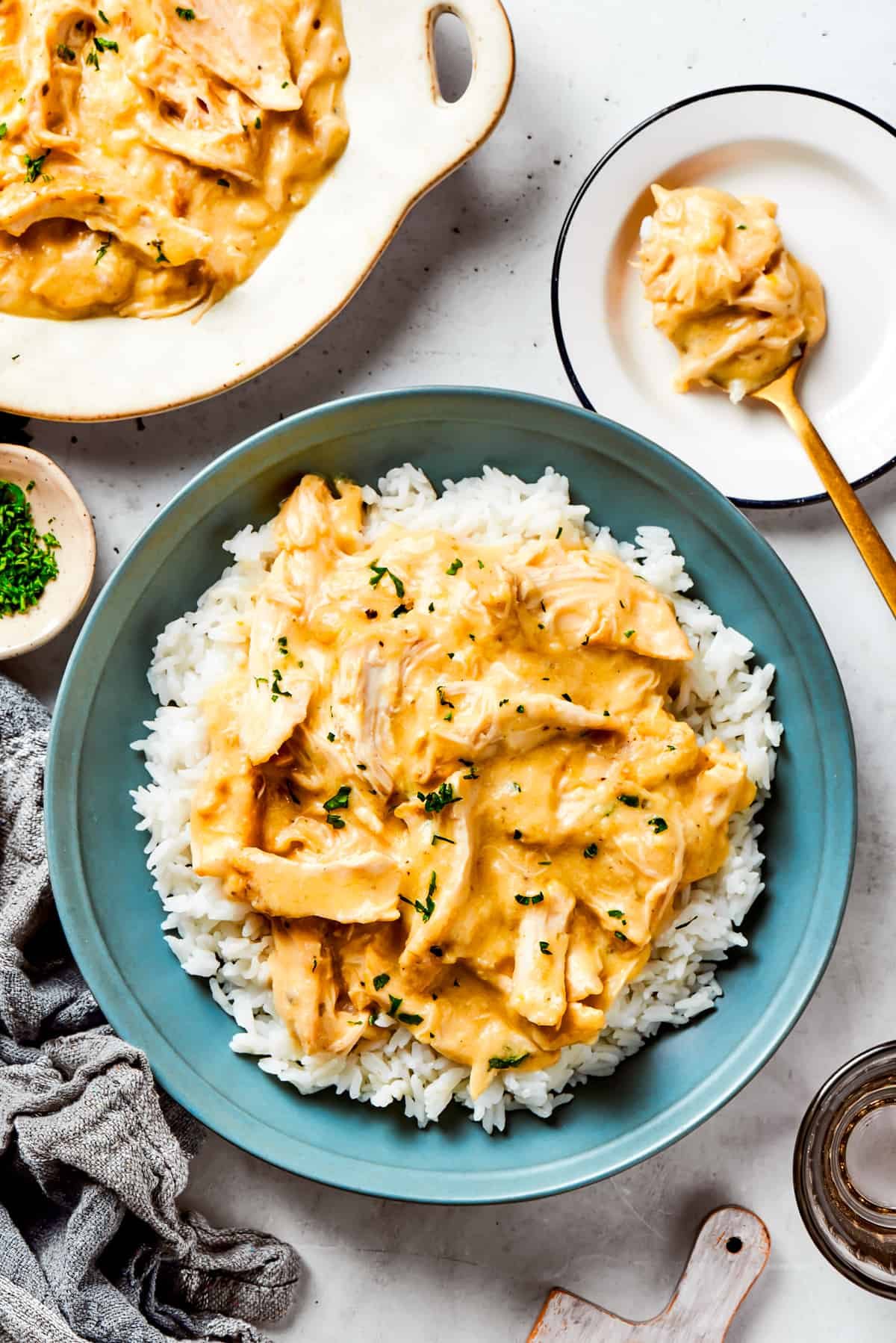 Chicken gravy served over a bed of rice in a blue bowl.