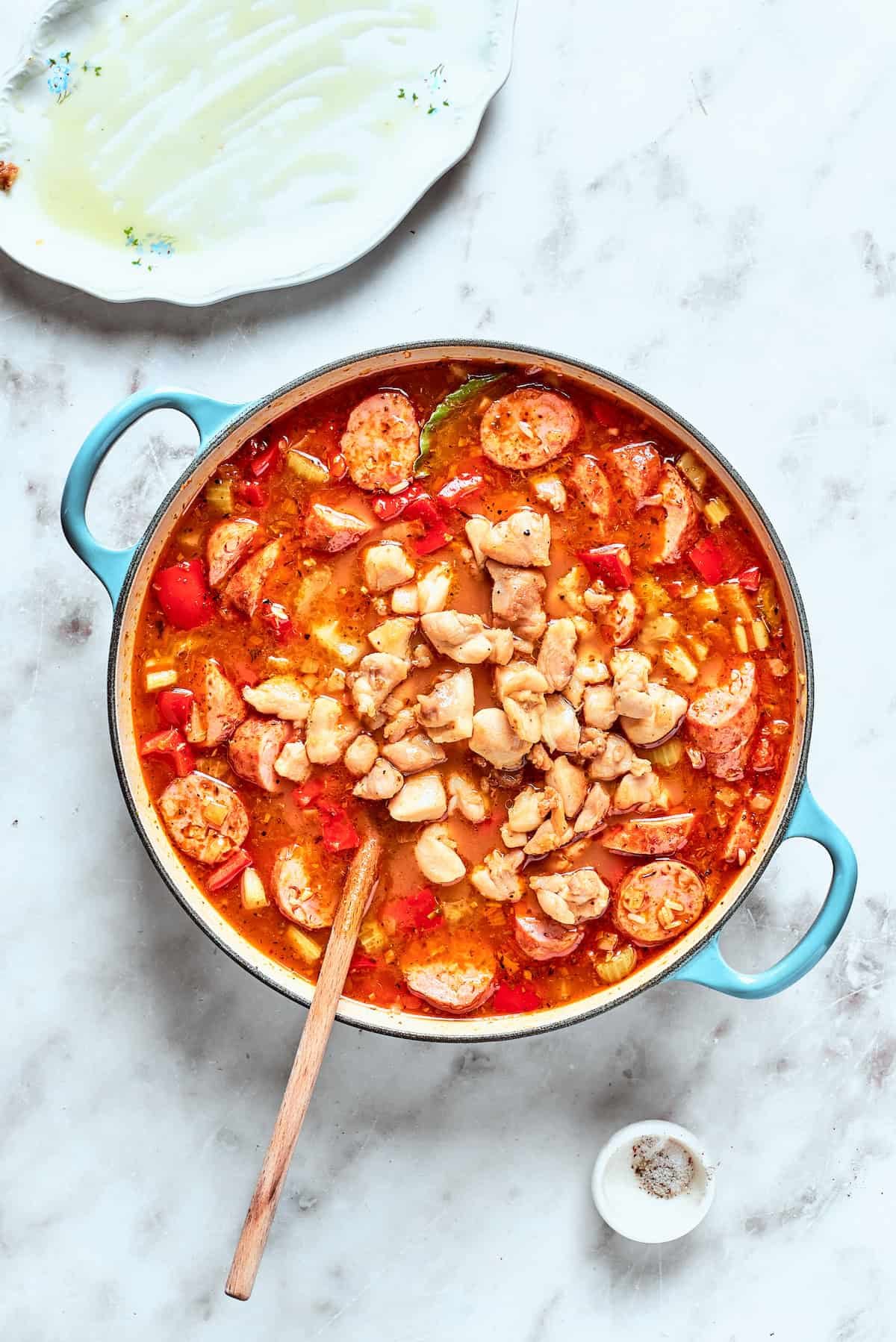 Chicken is stirred back into the jambalaya.