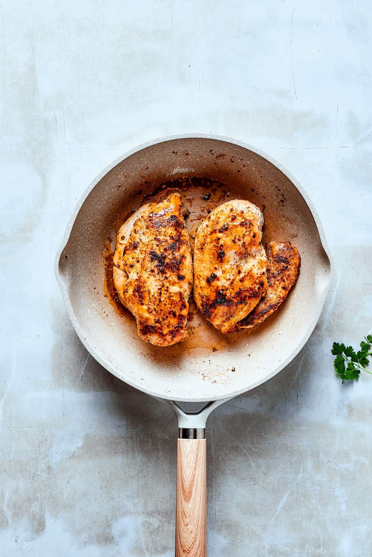 Cooking chicken in a skillet.